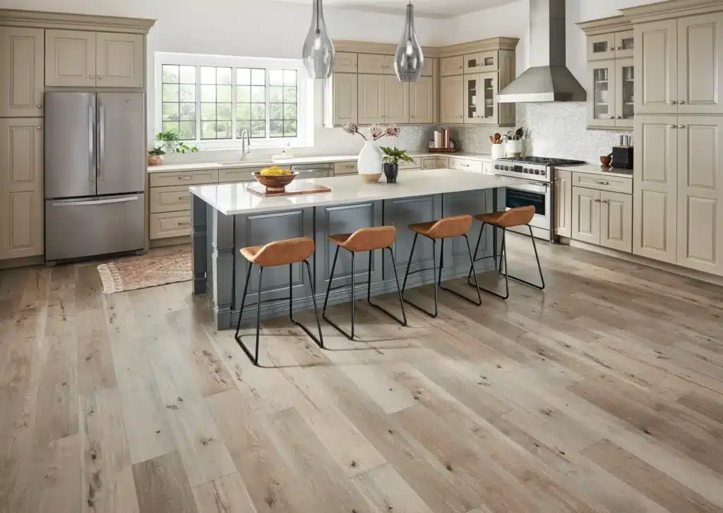 Large, bright kitchen with wood laminate flooring.