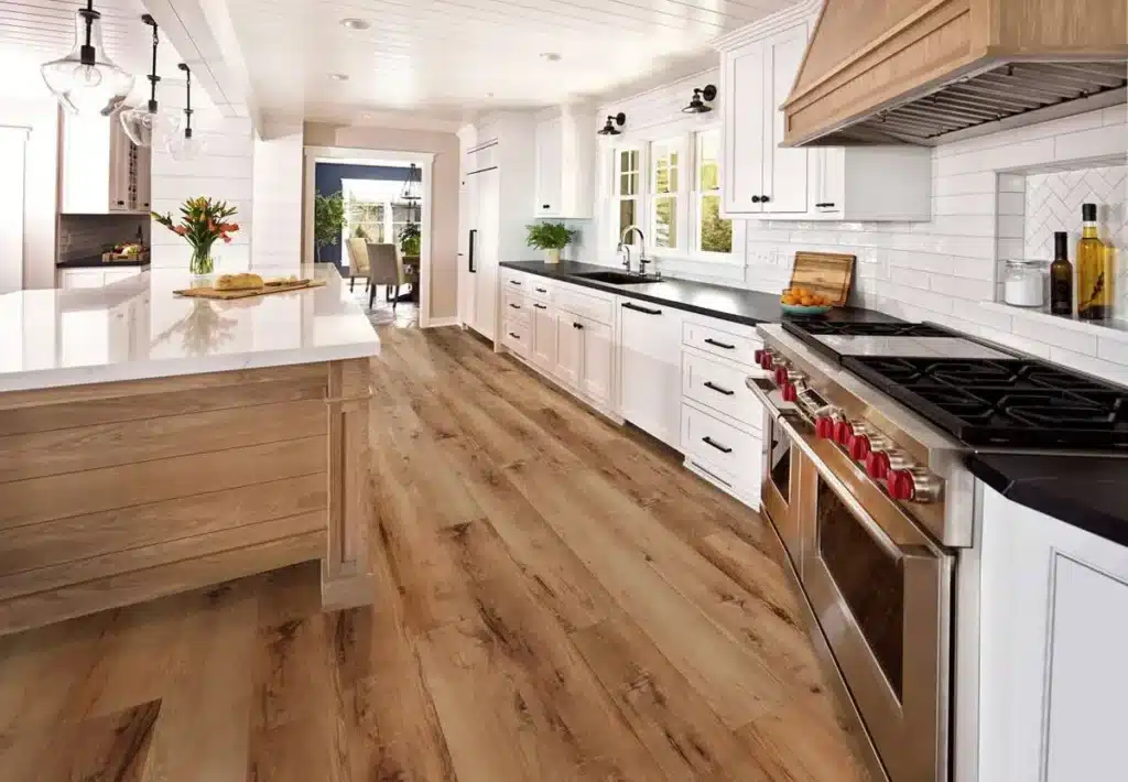 White kitchen with luxury plank flooring.